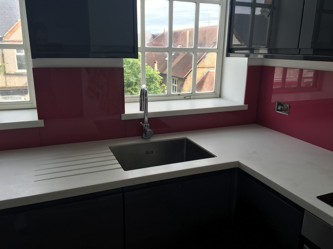 Deep plum coloured glass splashback in modern Dunstable kitchen